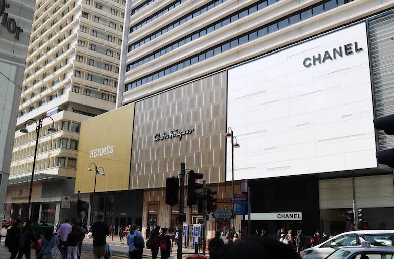 Protests and trade tensions hurt Hong Kong’s economy