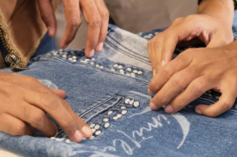 AGI embroiders denim with braille writing
